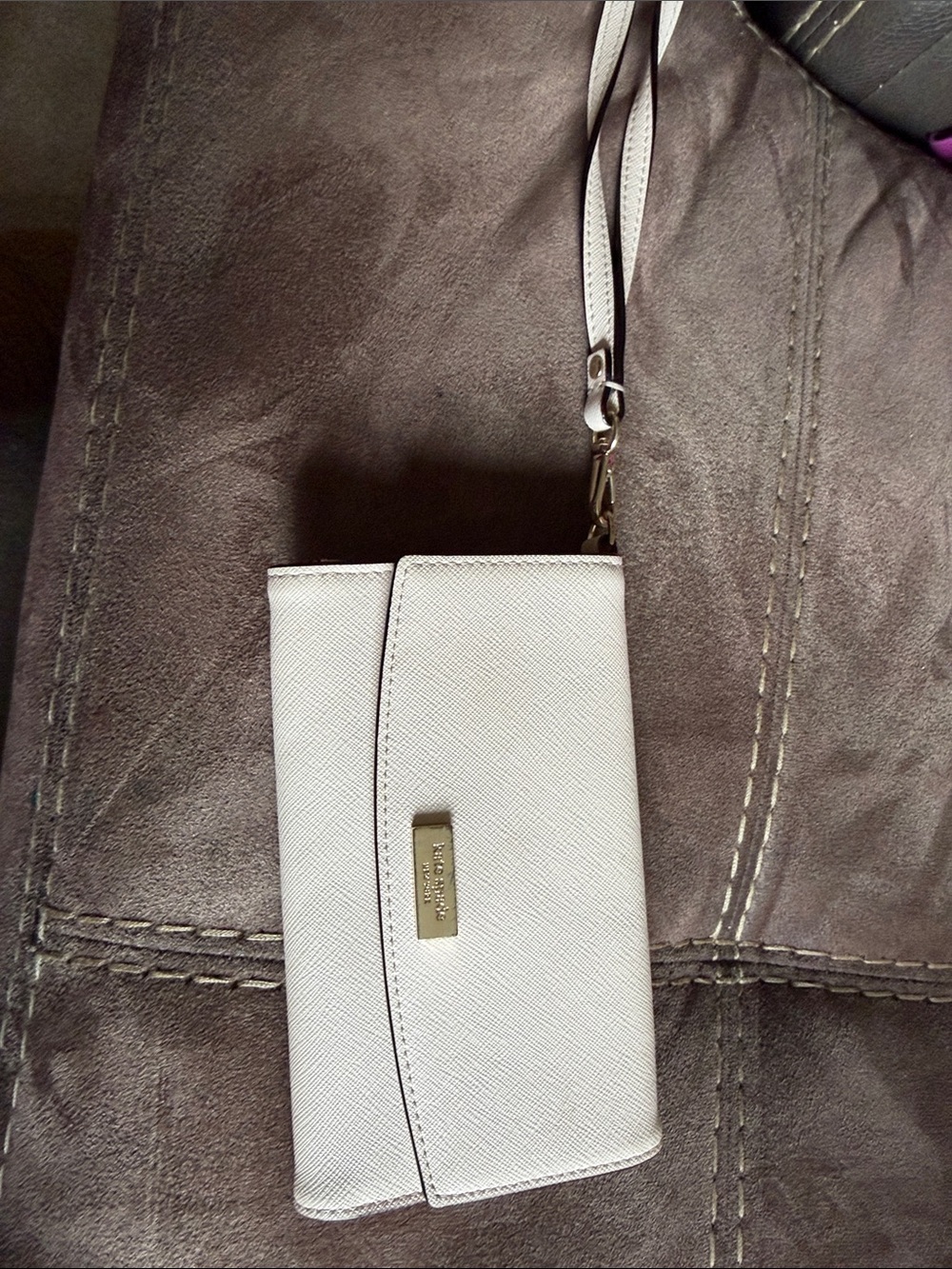 kate spade ivory wristlet clutch with gold-tone plaque